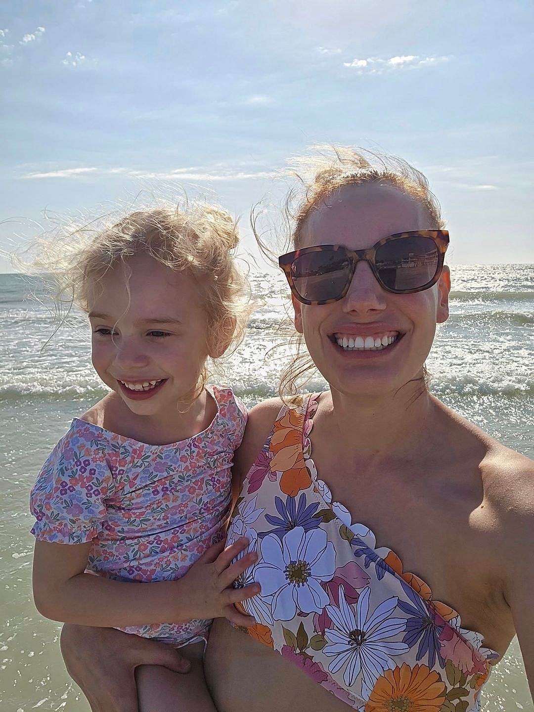 Woman at beach holding child