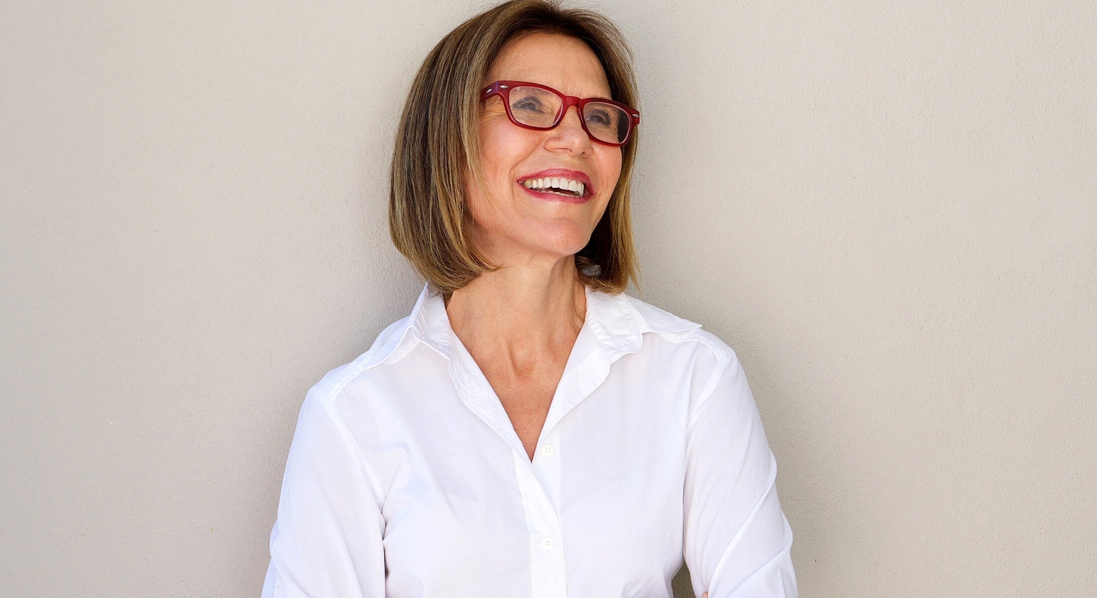 Woman holding clear round objects, smiling.